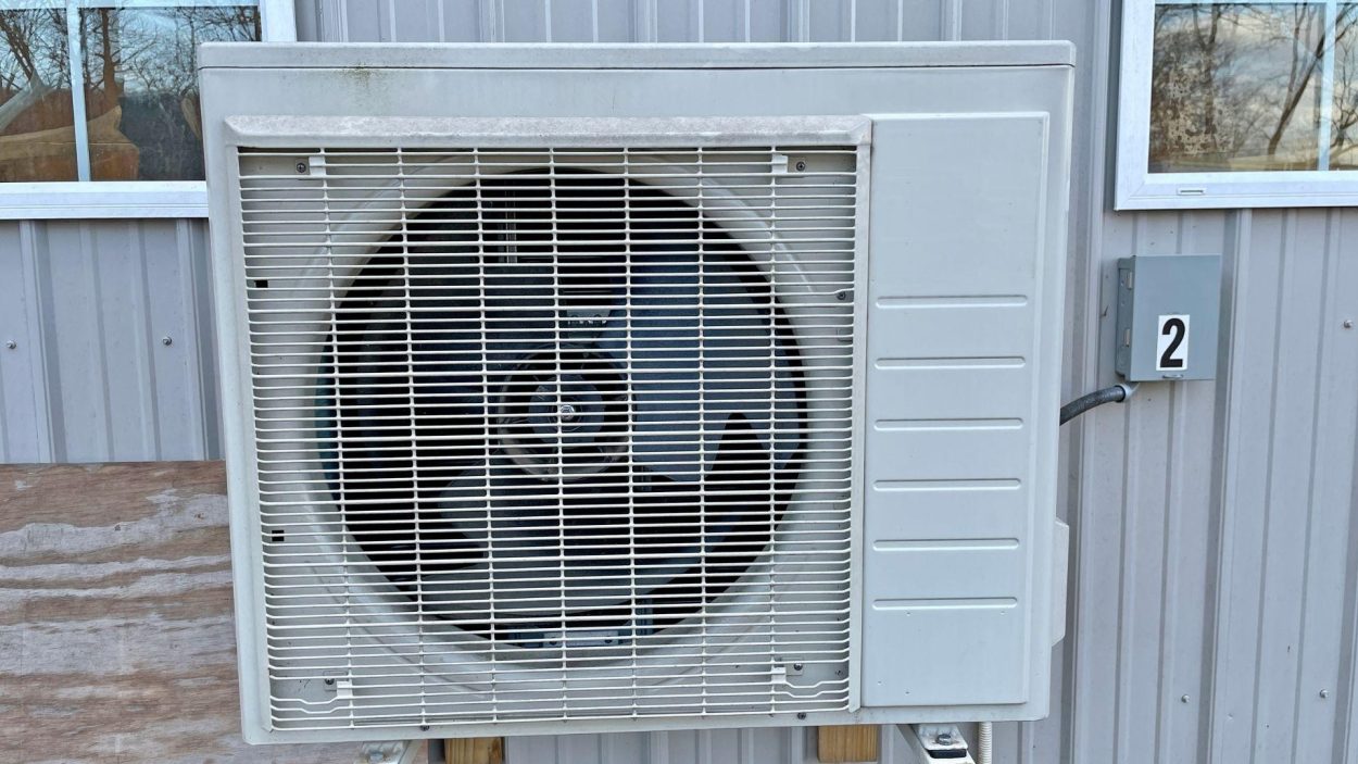Close-up of an AC unit on a building. Key factors to consider when choosing the right AC for Atlanta, GA homes include efficiency and size.