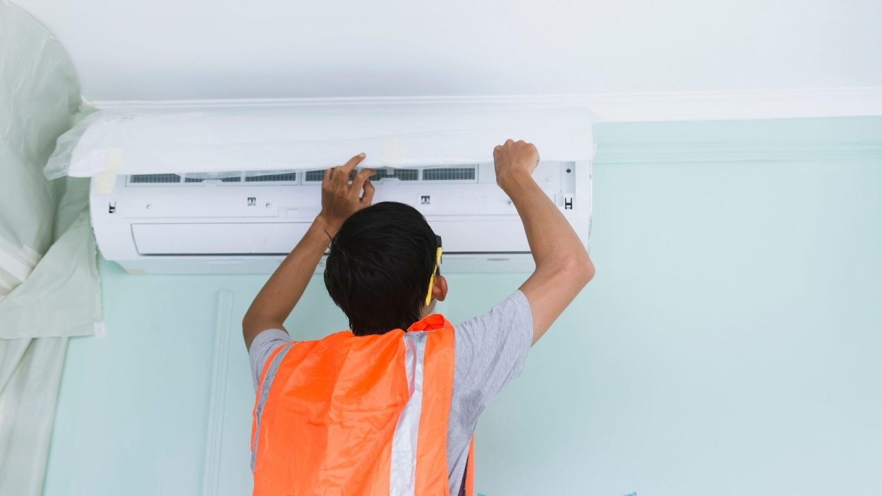 AC Repair in Atlanta, GA: Technician servicing a mini-split air conditioner unit for comfortable living, ensuring optimal performance.