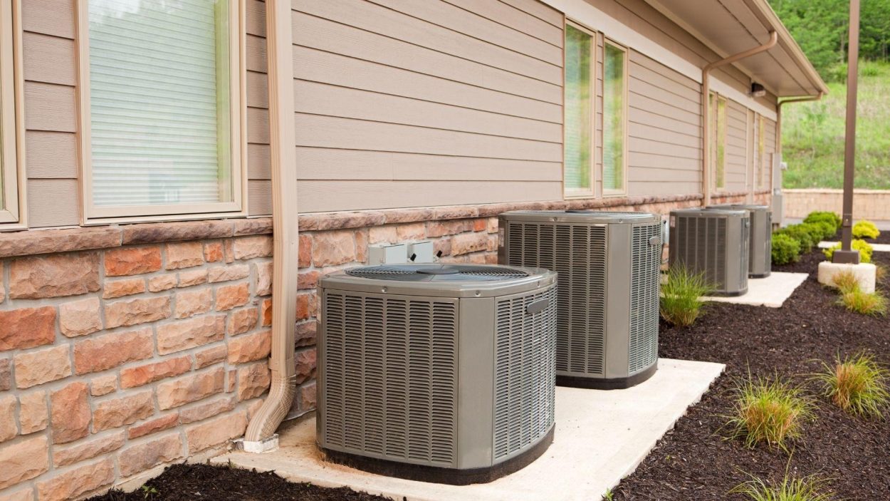 Row of Trane HVAC units outside building. Find top Trane models and dealers in Atlanta, GA for your home's heating and cooling needs.