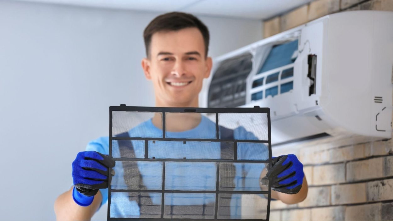 Technician holding dirty AC filter. Common signs your AC needs repair include poor airflow. Atlanta, GA AC repair can help.