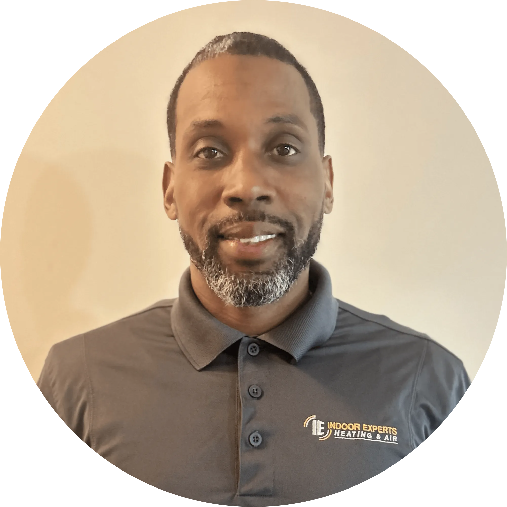 Homepage: Portrait of a friendly service provider wearing an Indoor Experts Heating & Air shirt, representing reliable home services.
