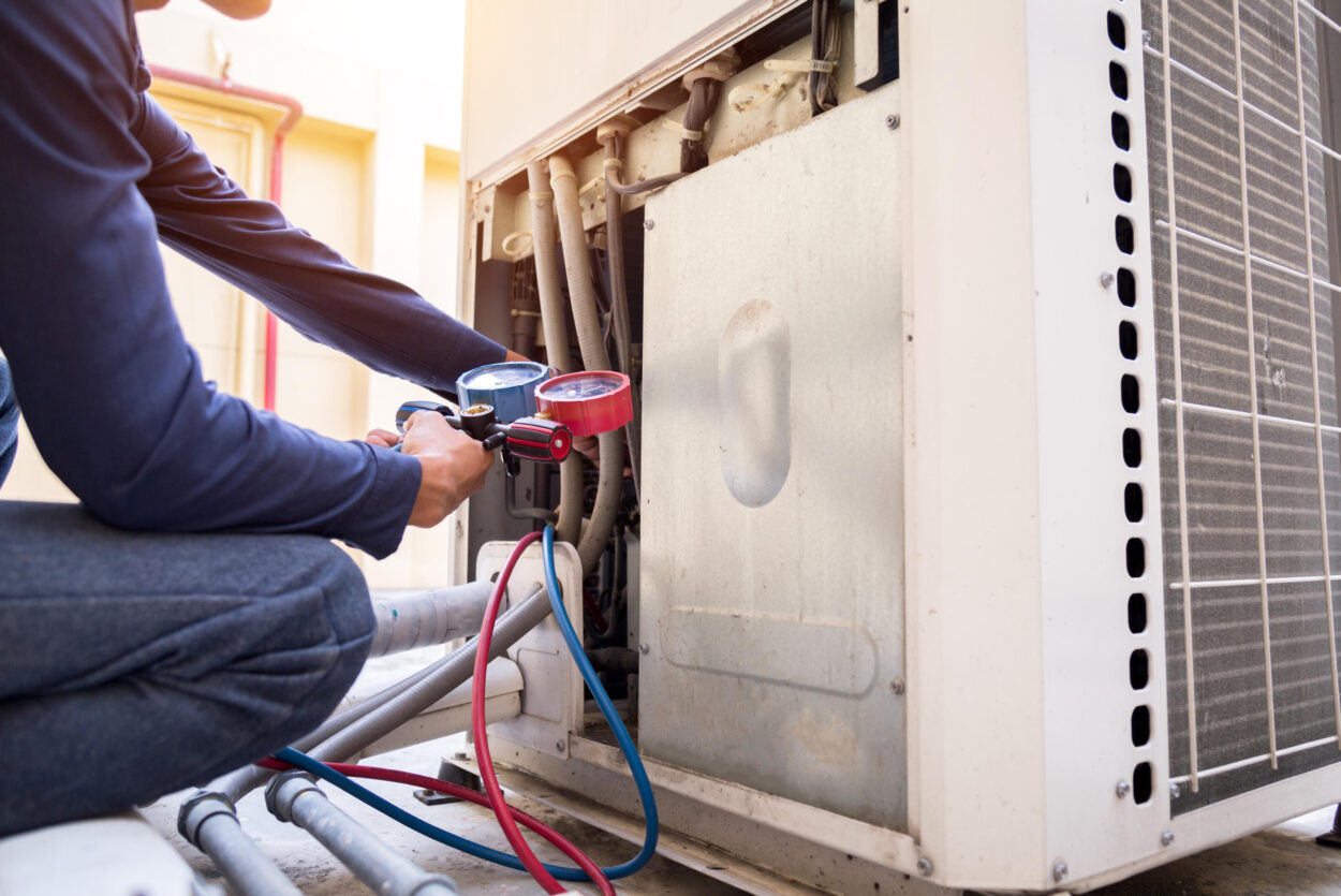 Heat pump technician performing maintenance and repair in Atlanta, GA.
