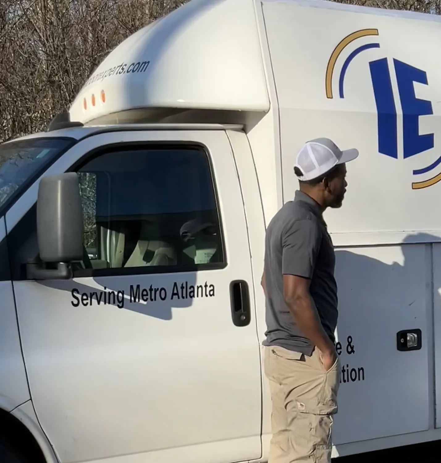 An Indoor Experts technician at the company service truck on a job in Atlanta