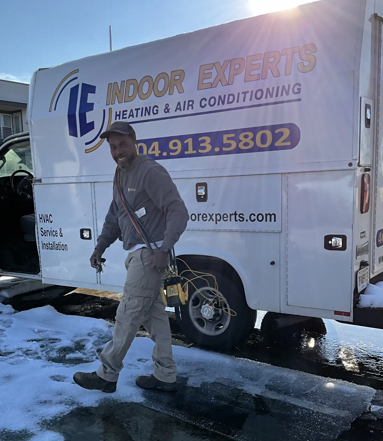 Indoor Experts technician walking past the company service van in Atlanta